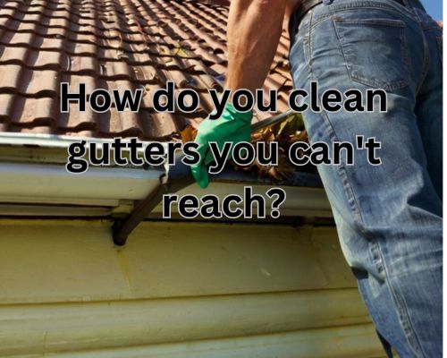 man-cleaning-roof-gutter-while-on-a-ladder